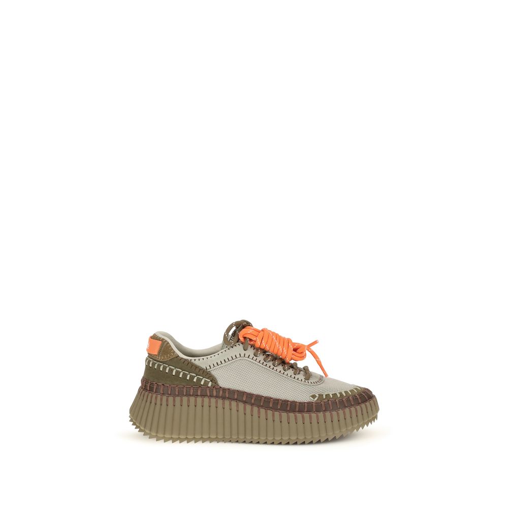 Sneaker with orange laces on a white background