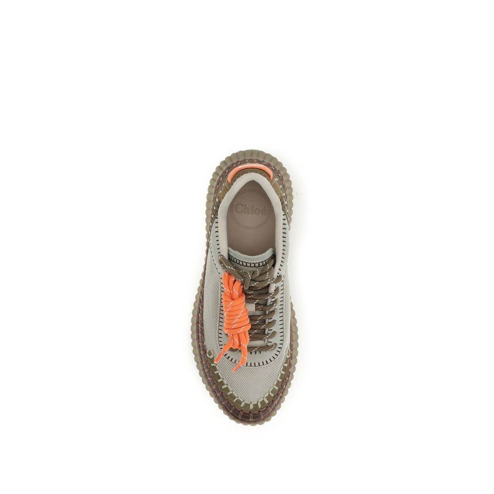 Sneaker with orange laces on a white background