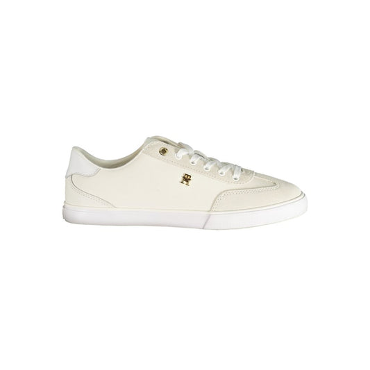 Tommy Hilfiger white polyurethane low-top women's sneaker with gold branding detail on a white rubber sole.