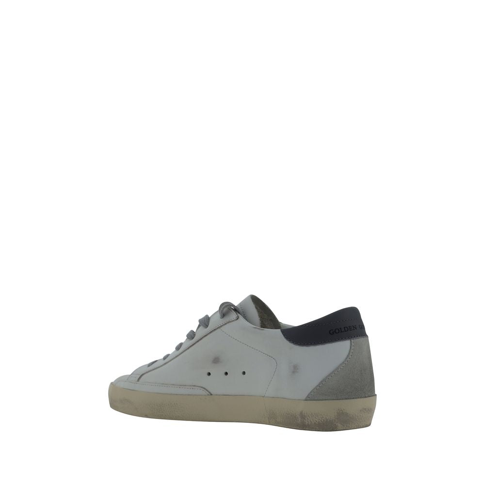 Golden Goose low-top sneakers in white goatskin leather with distressed soles and dark blue heel tab detail.