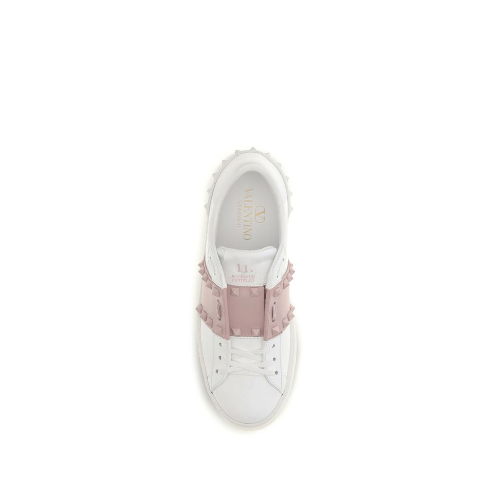 White sneaker with pink embellishments on a white background