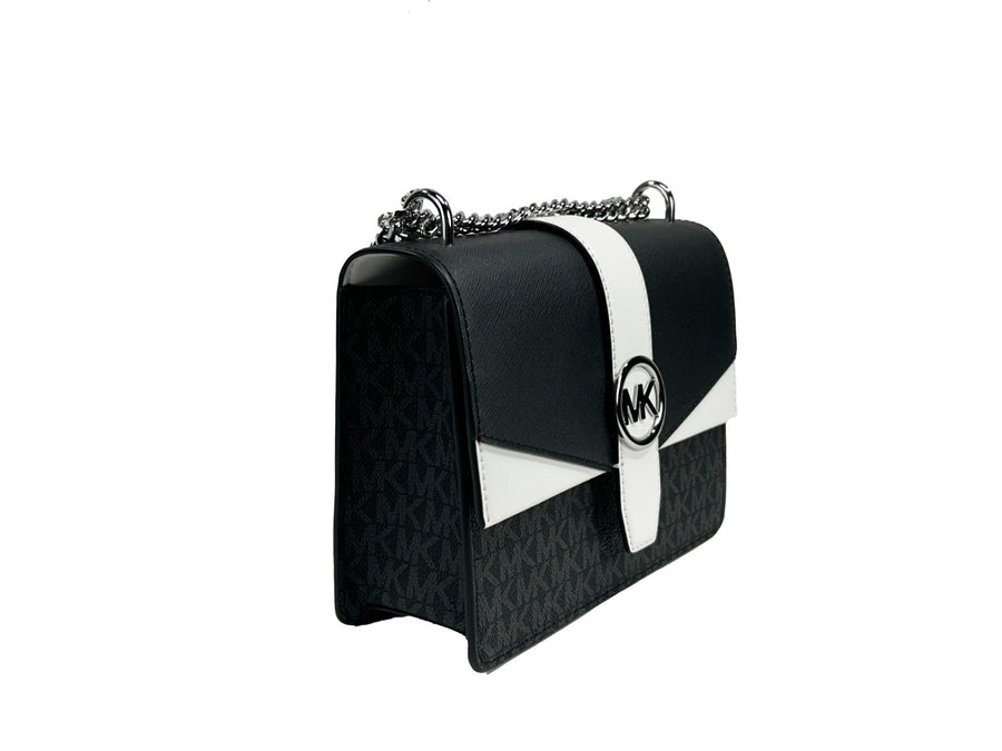 Black and white leather flap crossbody bag with silver chain strap and MK logo clasp