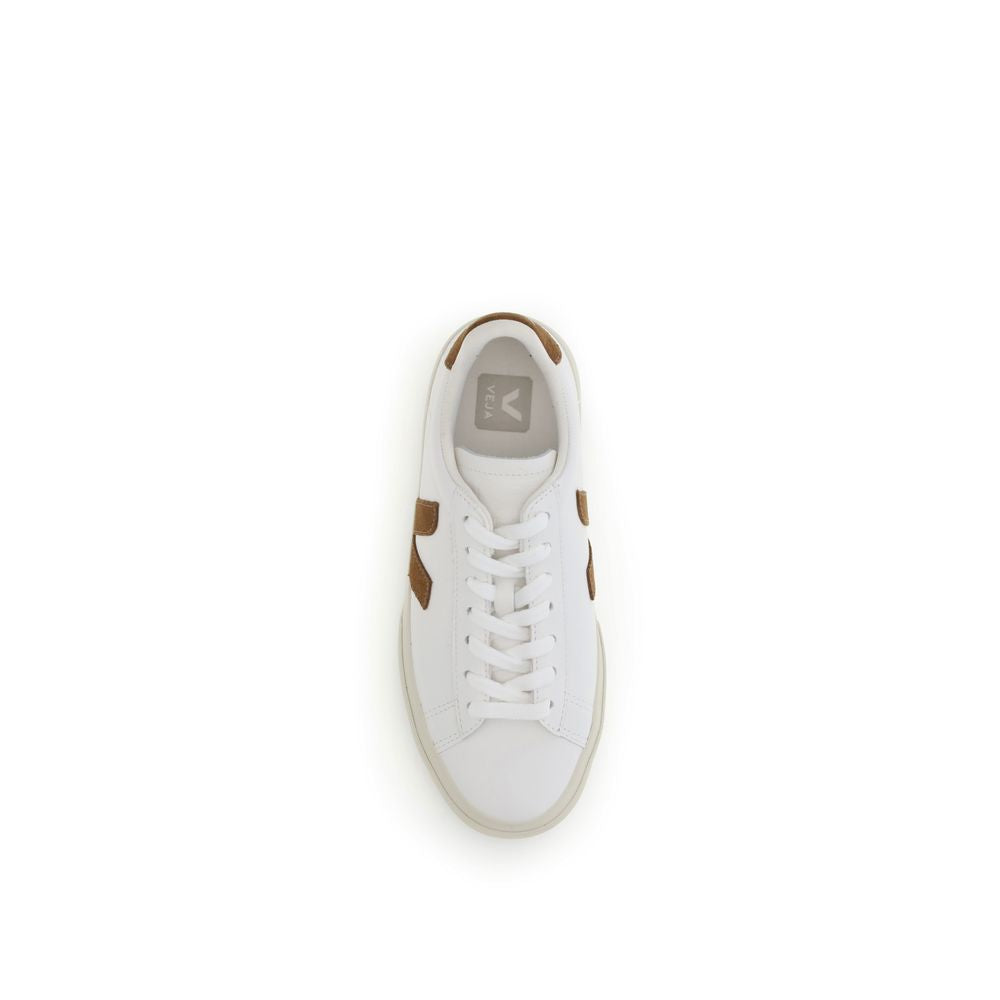 Top-down view of a white leather Veja sneaker with brown suede accents and lace-up closure on a white background.