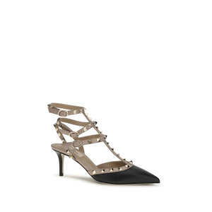 Valentino Garavani black calf leather pumps with beige buckled straps and gold-tone Rockstud accents, kitten heel.
