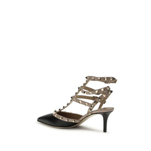 Black calf leather Valentino Garavani pumps with a beige strappy design, gold studs, and a sleek kitten heel.