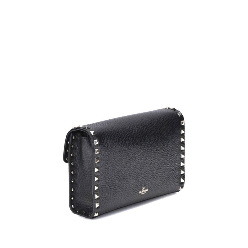 Black pebbled leather shoulder bag with metallic pyramid studs along the edges