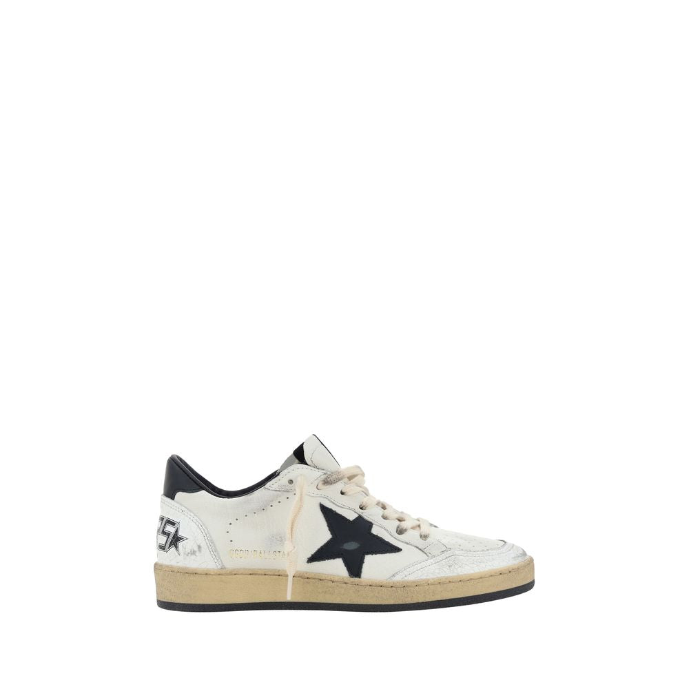 Golden Goose distressed white leather sneaker with a black star patch, heel tab, and textured, aged-look sole.