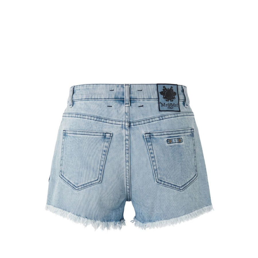 Light blue denim shorts with frayed hems and colorful embroidered patches