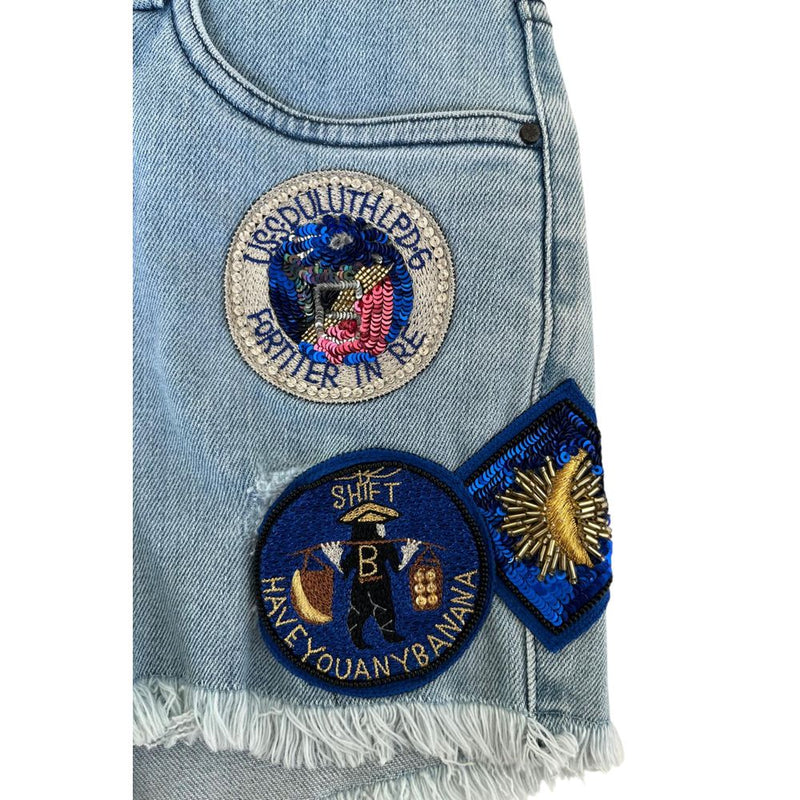Light blue denim cotton women's short with embroidered patches and frayed hem