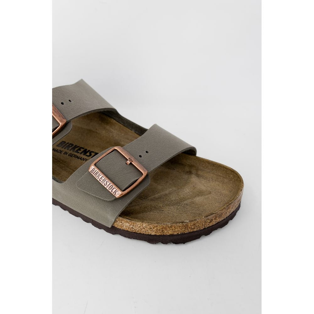 Olive green Birkenstock slide sandal with a cork footbed and copper-colored buckles.