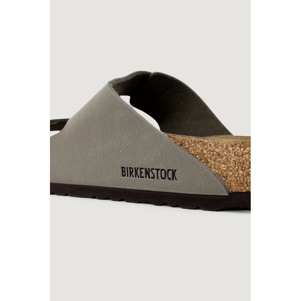 Close-up of a grey Birkenstock slide sandal featuring a textured strap, cork footbed, and dark brown sole.