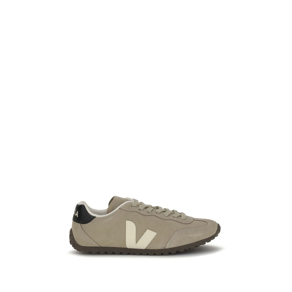 Beige suede low-top sneaker with a white V logo, black heel tab, and a brown rubber sole.