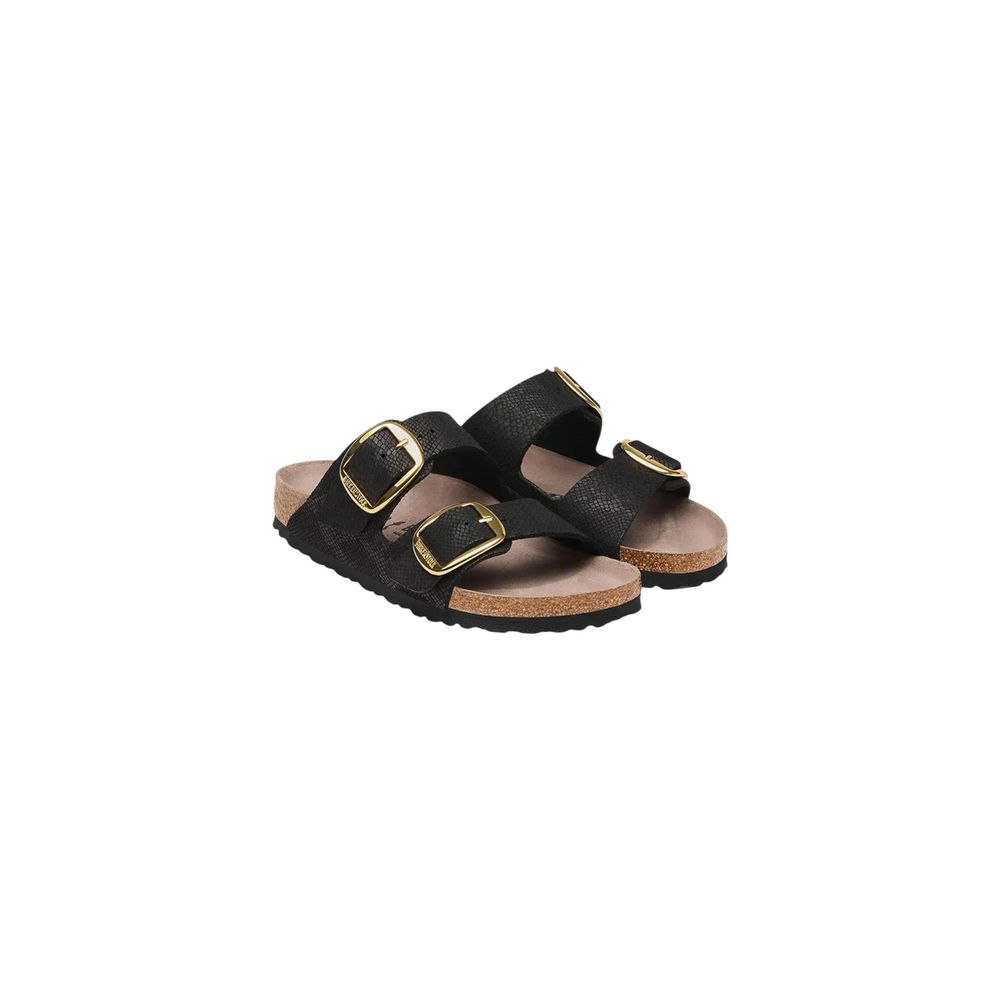 Black textured two-strap Birkenstock-style sandals with gold buckles and cork footbeds on a white background.
