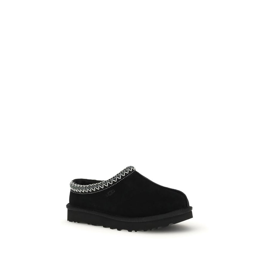 Black suede UGG mule with platform sole and woven trim collar