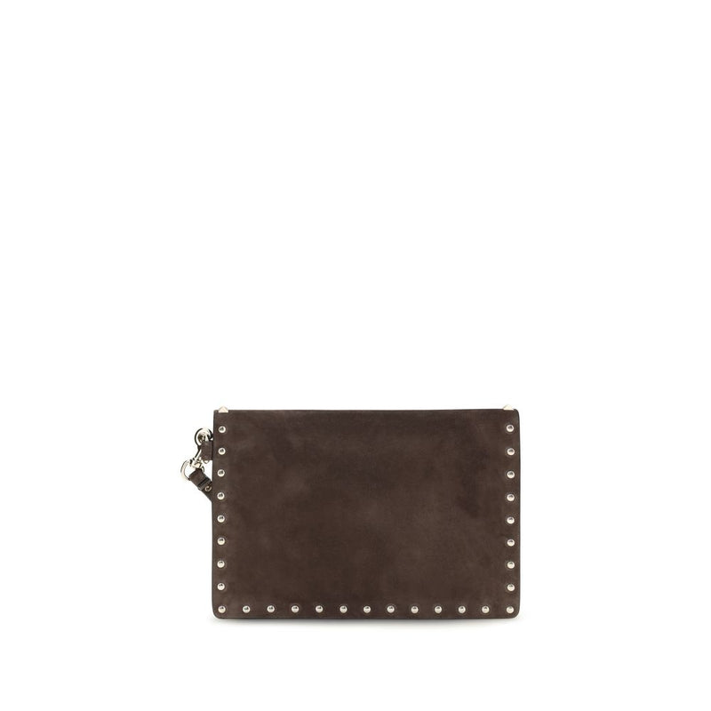 Brown suede clutch bag with silver studs along the edges and a wrist strap