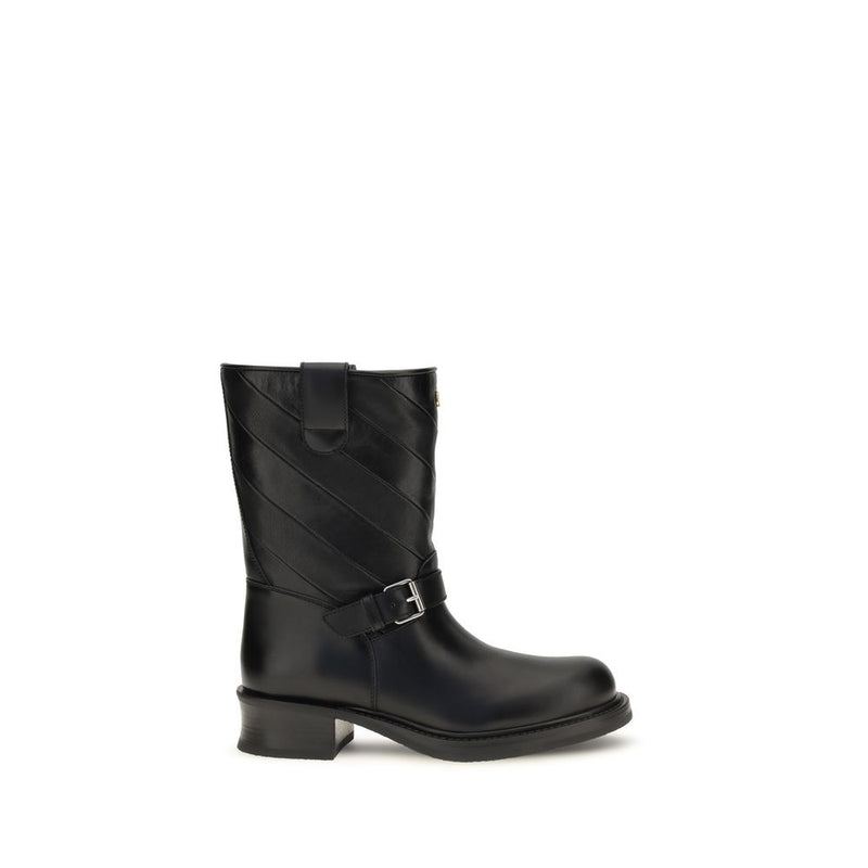 Black leather calf boot with diagonal quilting and a buckled ankle strap