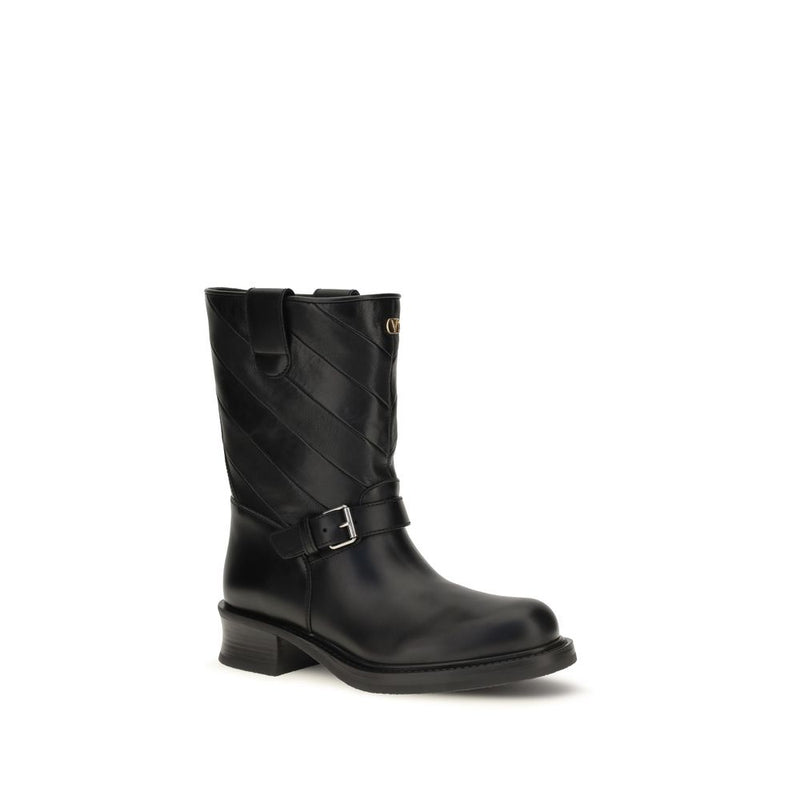 Black leather ankle boot with diagonal quilting and a buckled strap
