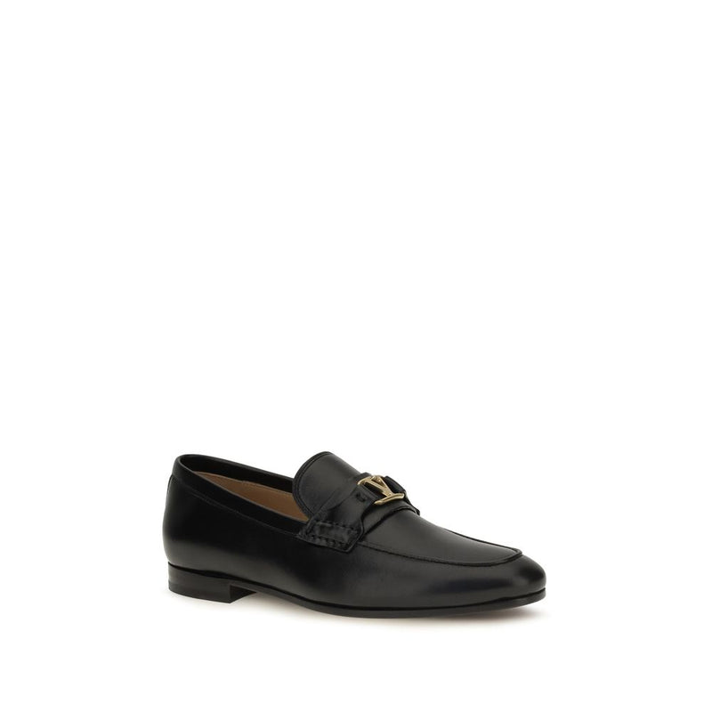 Black leather slip-on loafer with gold hardware