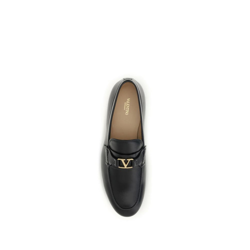Black leather slip-on loafer with a gold V logo detail on the front