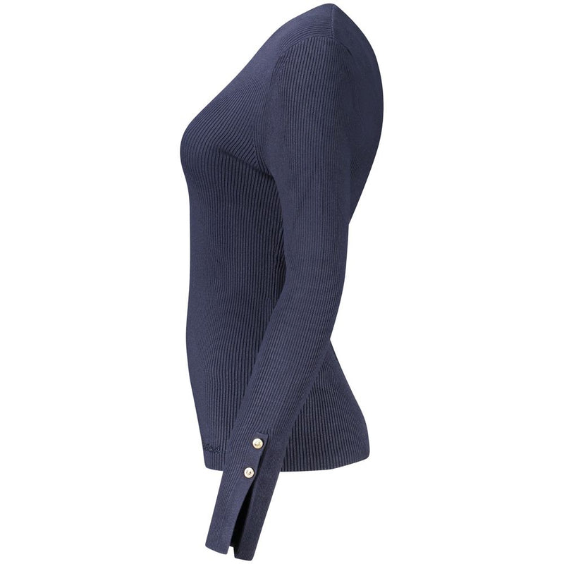 Side view of a blue ribbed viscose women's sweater with gold buttons on the cuffs