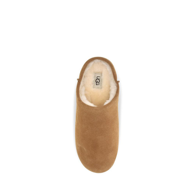 Beige suede mule with plush white shearling lining
