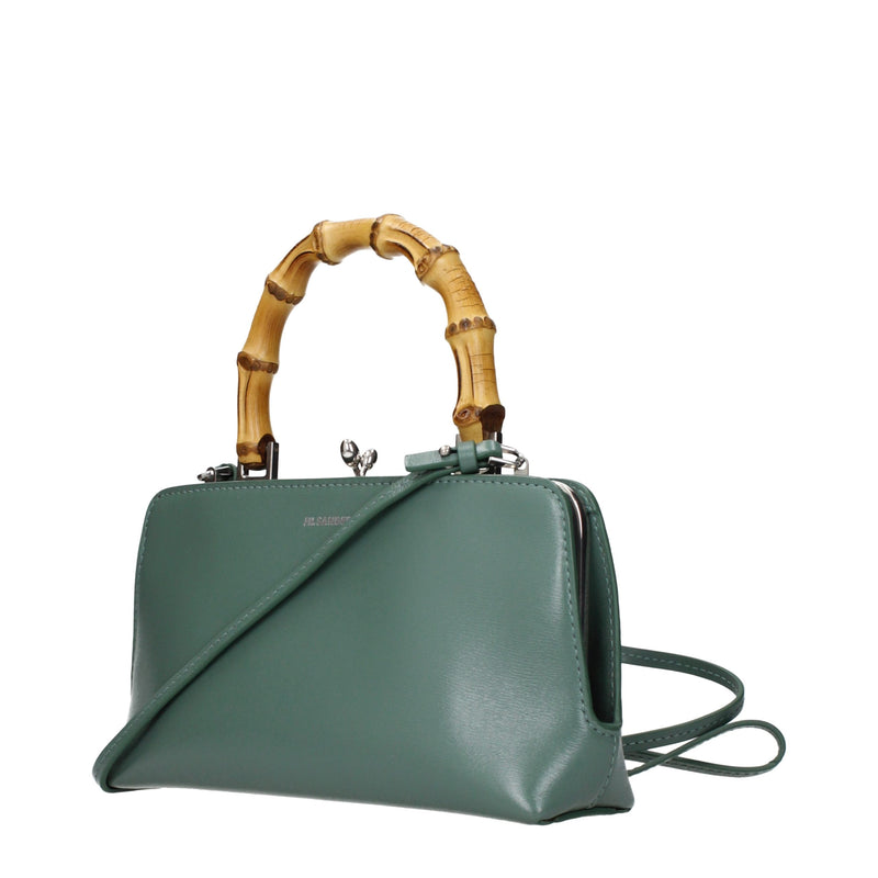 Sage green leather handbag with a curved bamboo handle and a crossbody strap