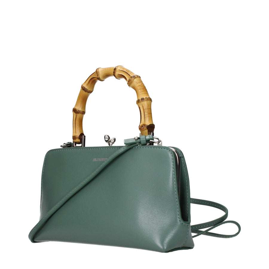 Sage green leather handbag with a bamboo top handle and kiss-lock closure