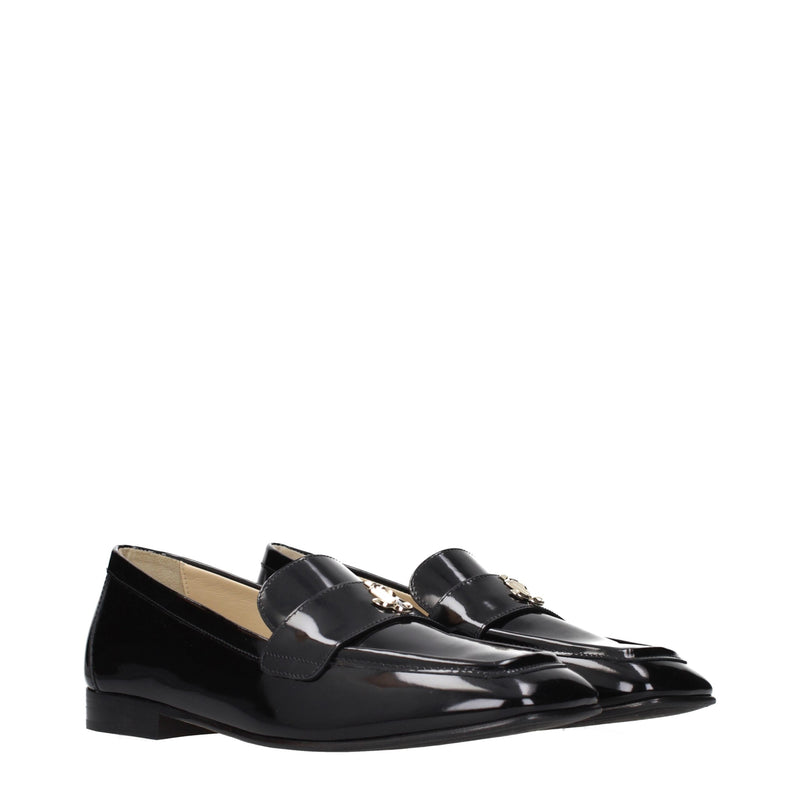 Black leather slip-on loafers with square toes and gold-tone hardware detail