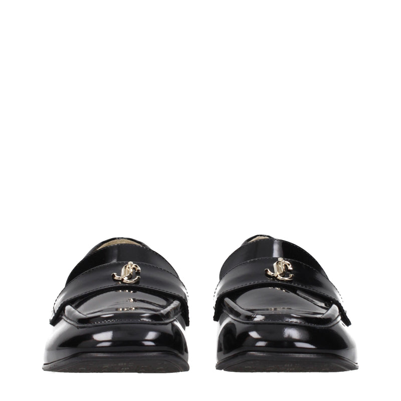 Black patent leather slip-on loafers with gold logo hardware