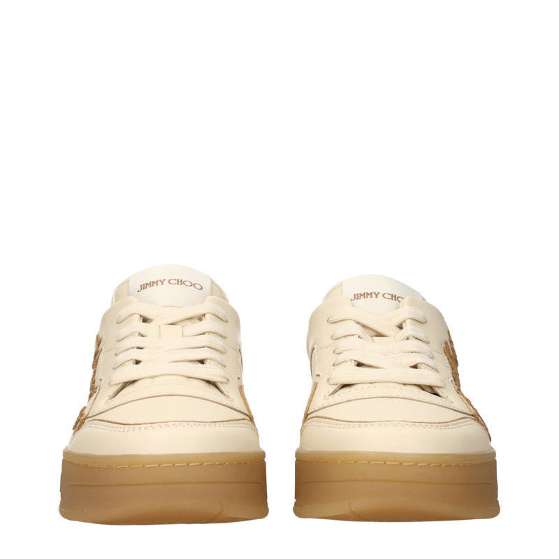 Pair of beige leather low top sneakers with flat laces and gum rubber soles
