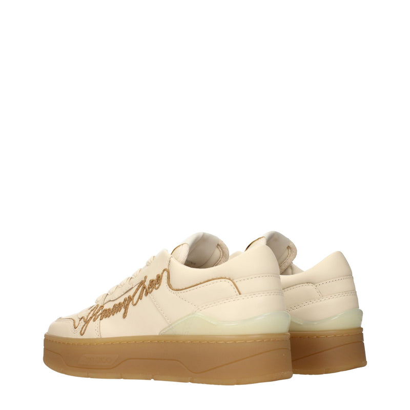 Beige leather low-top sneakers with thick rubber soles and embroidered side logo