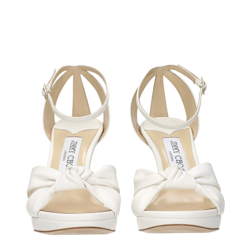 White leather platform sandals with ankle straps and knotted toe bows