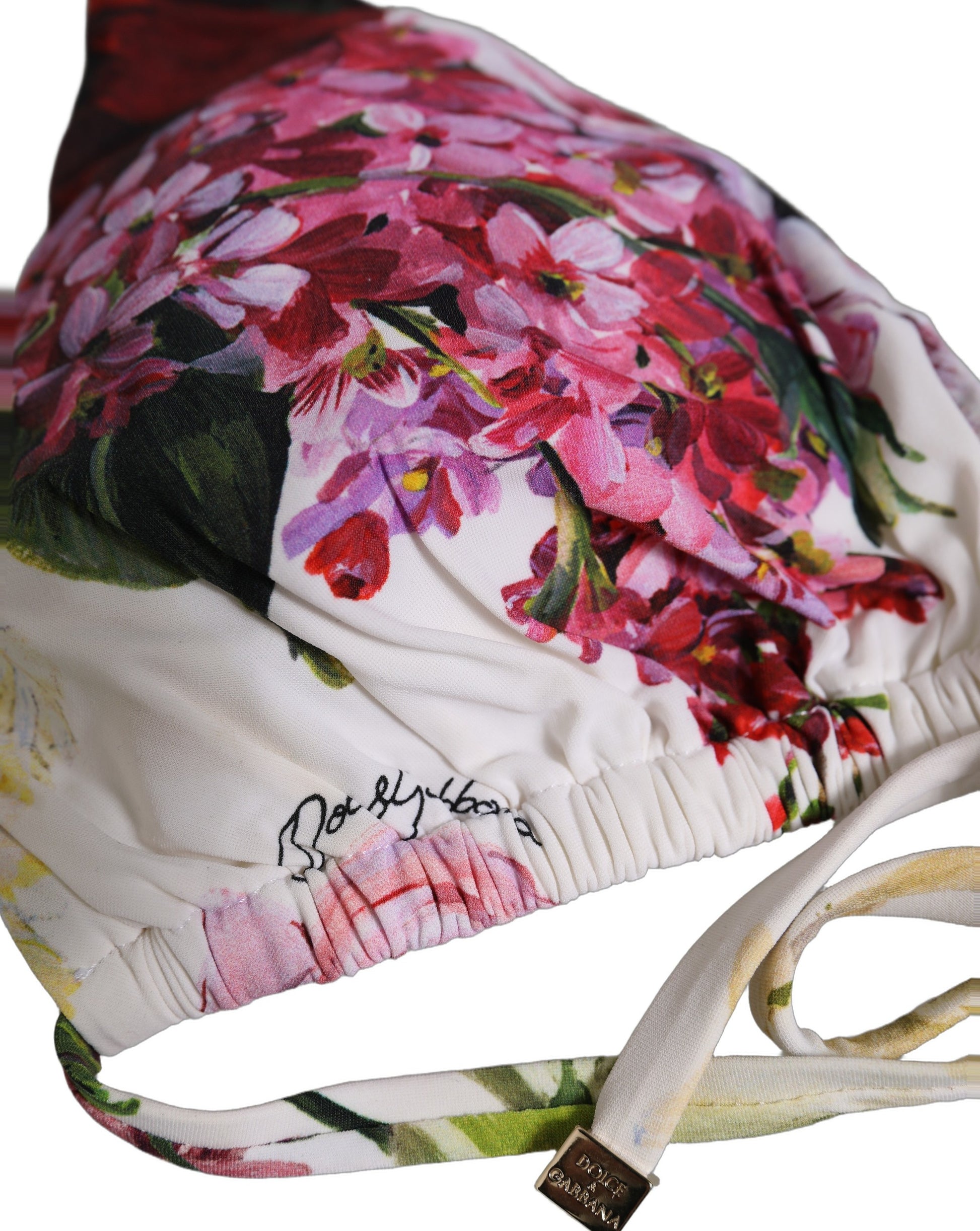 White floral print triangle bikini top with ruched underband and metallic logo charm.