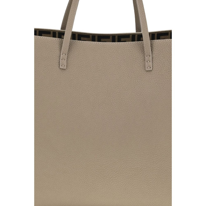 Beige pebbled leather shoulder bag with tall thin straps and visible stitching