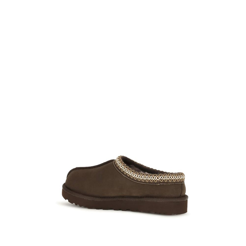 Brown suede UGG slip-on mule with decorative woven trim along the collar