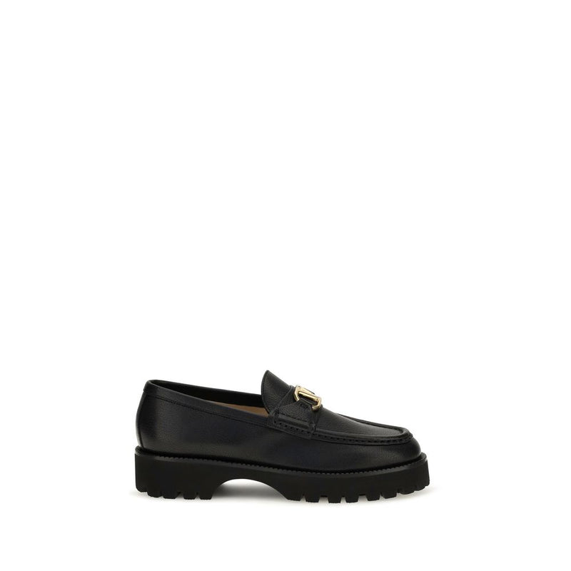 Black goatskin platform loafer with a lug sole and gold hardware