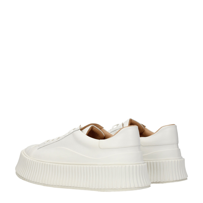White leather platform sneakers with thick ridged soles shown from the rear angle