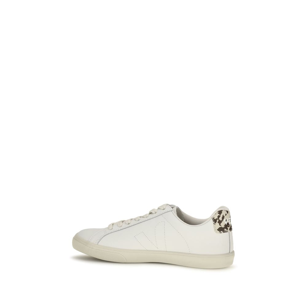 Veja white leather low-top sneaker, side profile showing tonal V logo, laces, and cow-print heel tab.