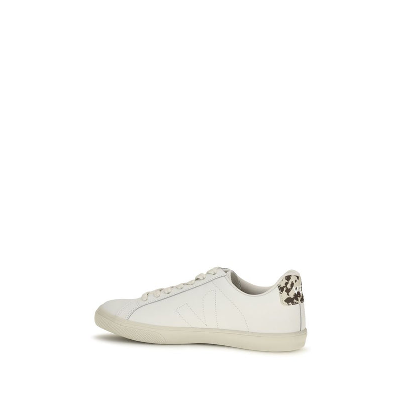Veja white leather low-top sneaker, side profile showing tonal V logo, laces, and cow-print heel tab.