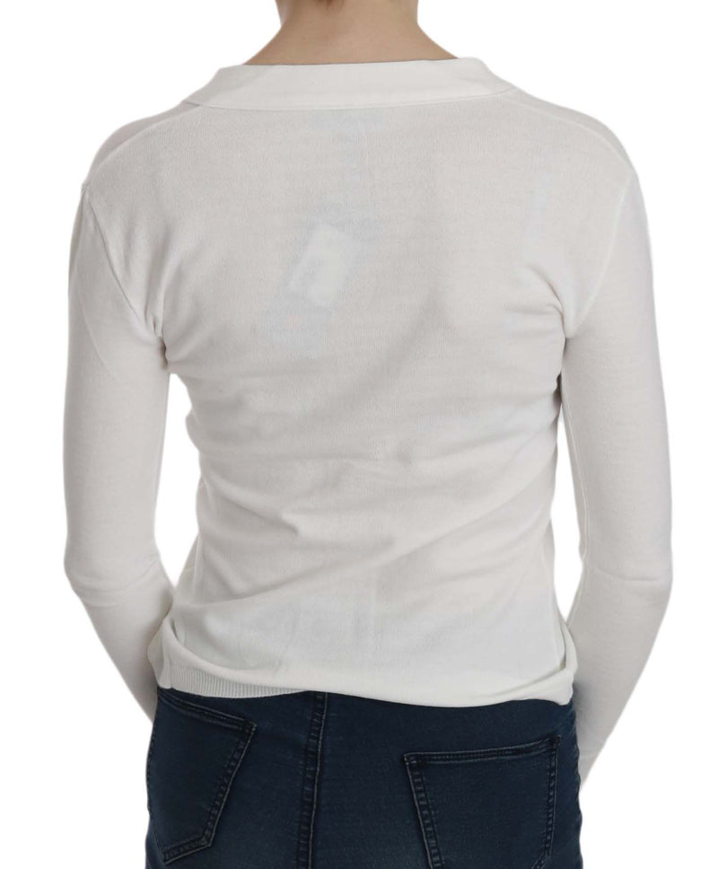 White knitted long-sleeve sweater worn backwards, showing back collar and dark jeans