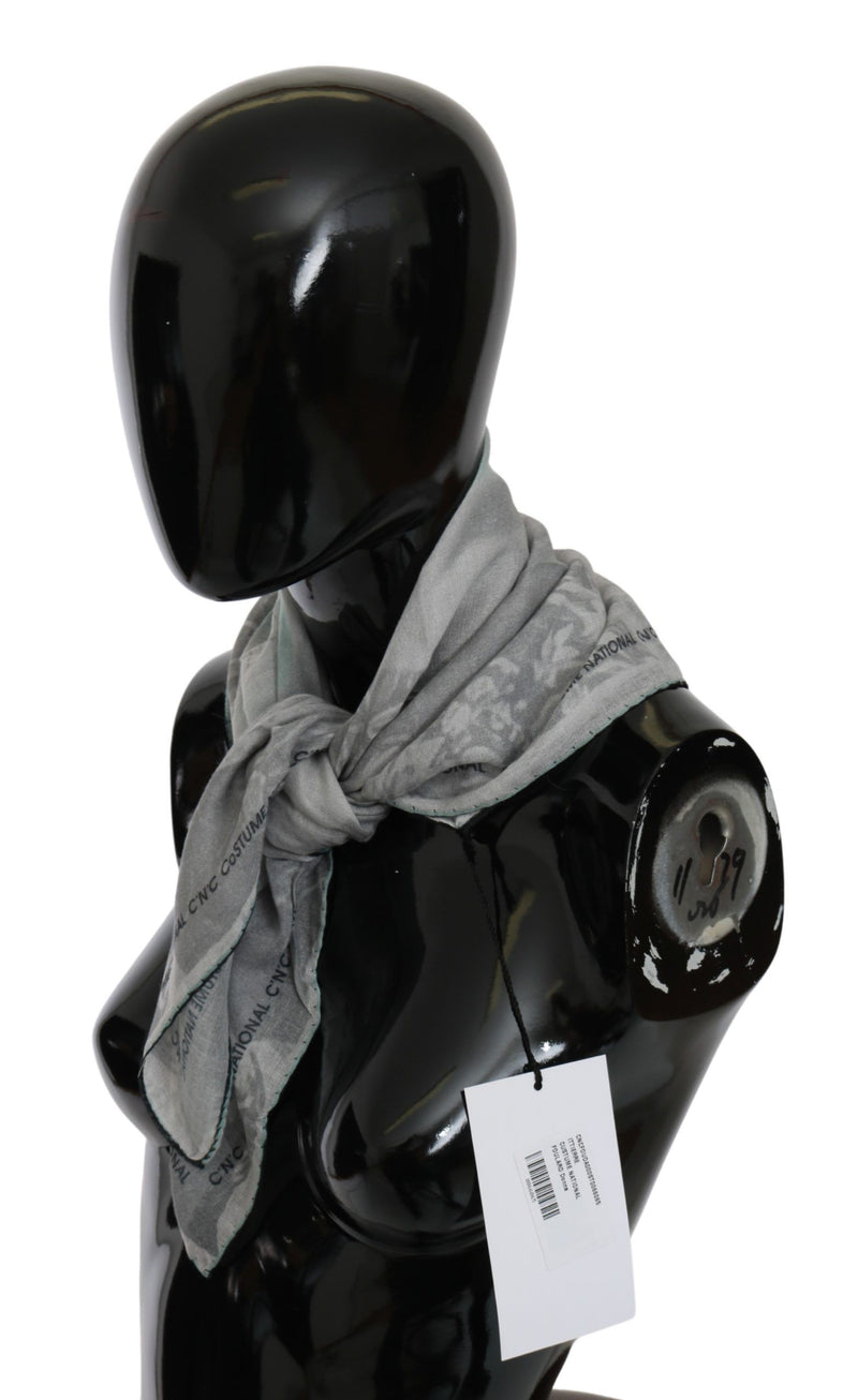 Gray silk shawl foulard scarf with a patterned design wrapped around a black mannequin