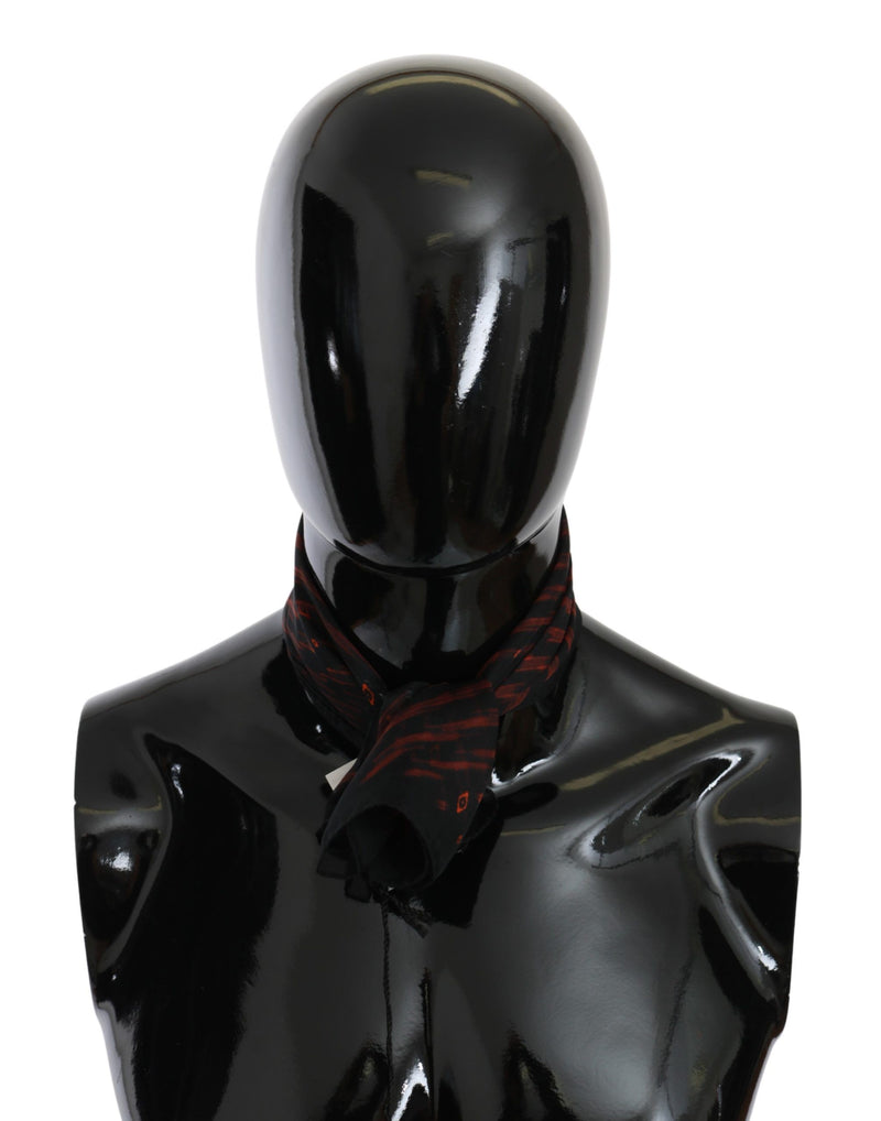 Black and orange patterned silk scarf tied around a black mannequin neck