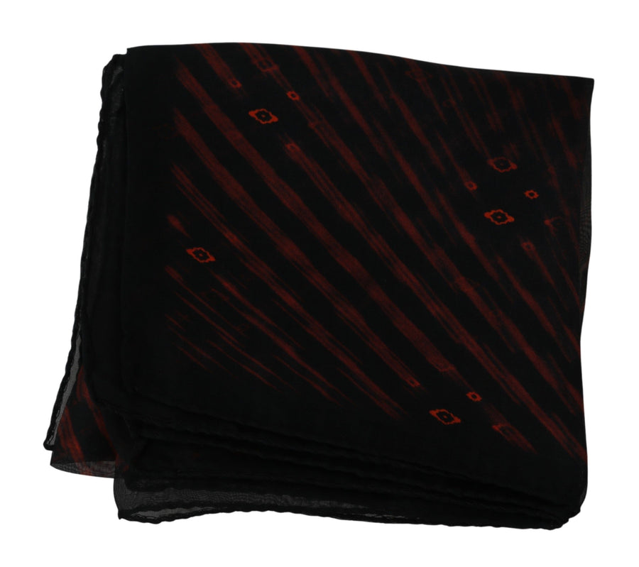 Black and orange patterned silk scarf tied around a black mannequin neck