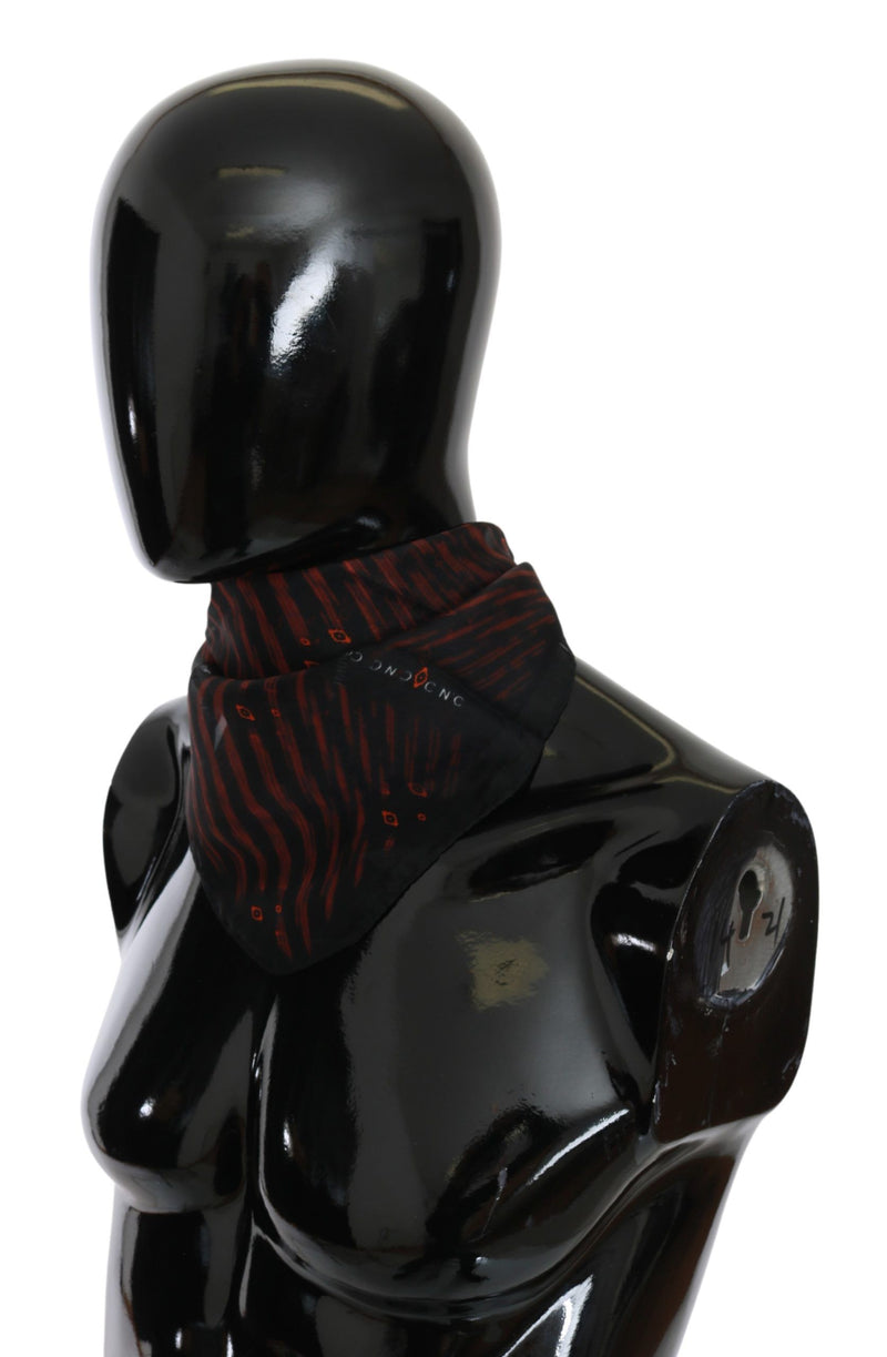 Black and orange silk printed scarf draped on a black mannequin
