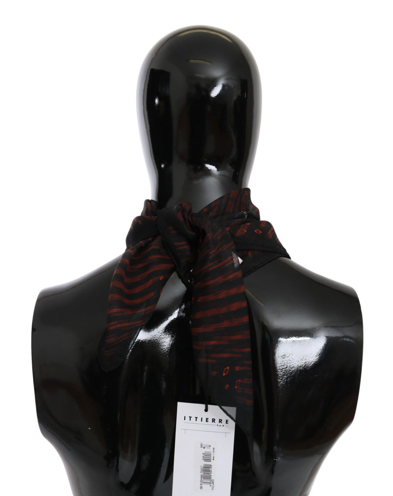 Black and orange patterned silk scarf tied around the neck of a glossy black mannequin