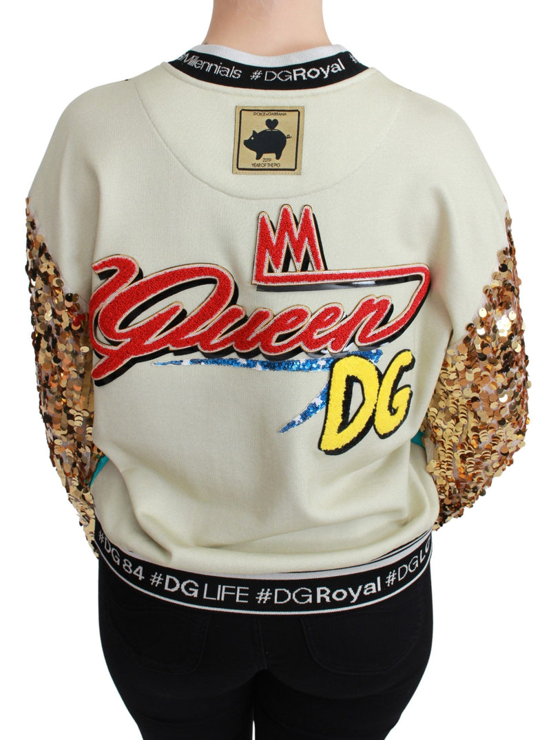 Cream crewneck sweater with sequin gold sleeves and colorful patches on back