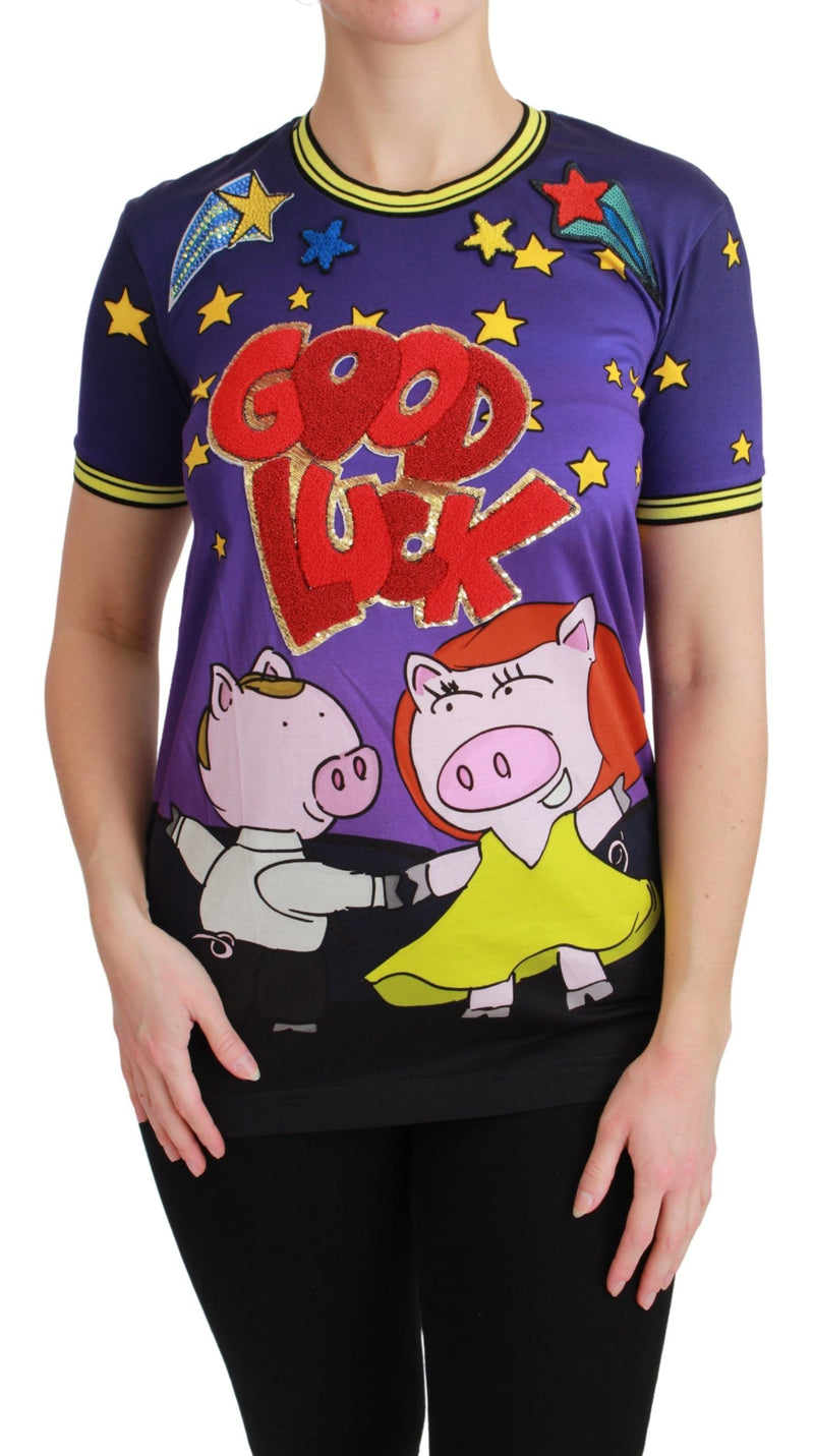 Purple cotton t-shirt featuring a "GOOD LUCK" graphic with dancing pigs and stars