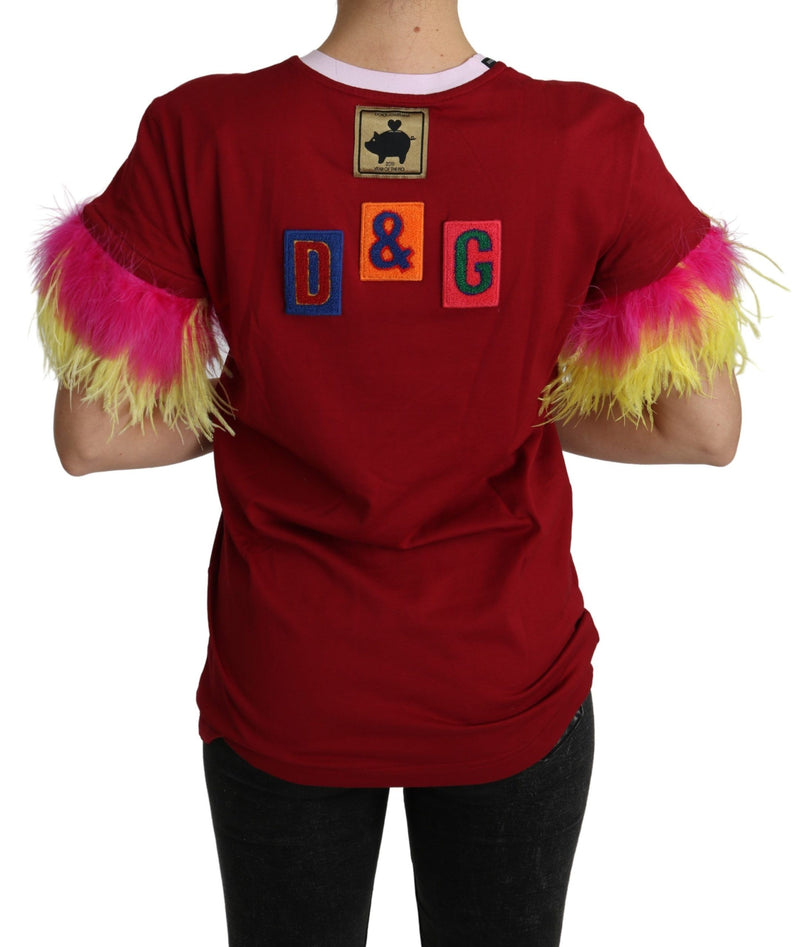 Red cotton t-shirt with pig patch, colorful D&G letters, and bright pink and yellow feather cuffs