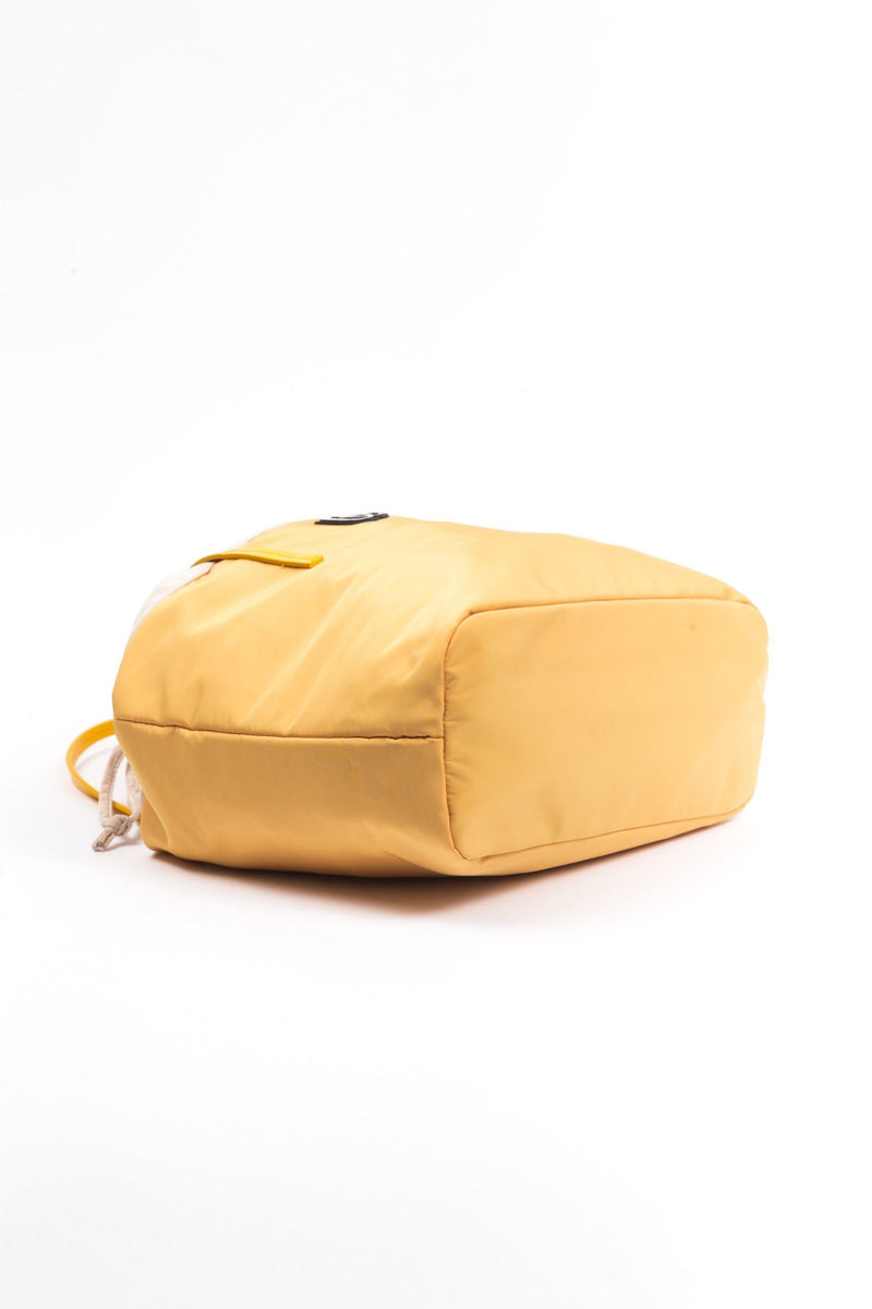 Yellow polyester shoulder bag laid flat on a white surface