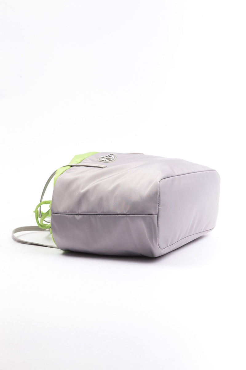 Gray polyester women's shoulder bag with lime green drawstring trim lying on white background